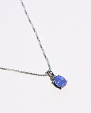 Natural tanzanite pendant necklace close up violet blue gemstone