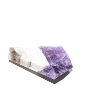 Trapiche amethyst point lying on side showing purple to white color transition