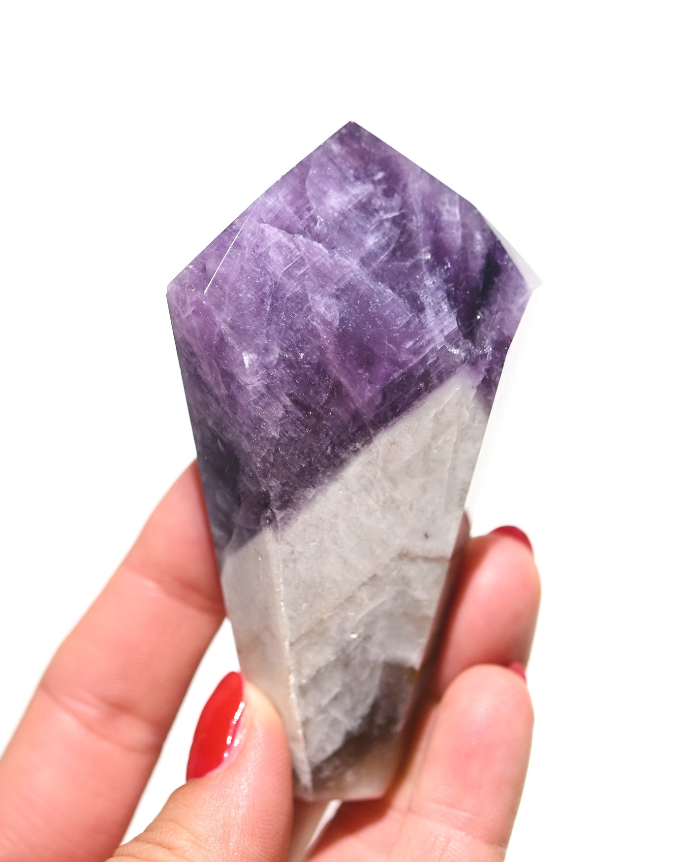 Trapiche amethyst point held in hand showing scale and deep violet color