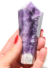 Trapiche Amethyst Point - hand-held view showing deep purple banding and white quartz base