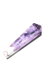 Polished trapiche amethyst tower lying on side showing purple to white transition