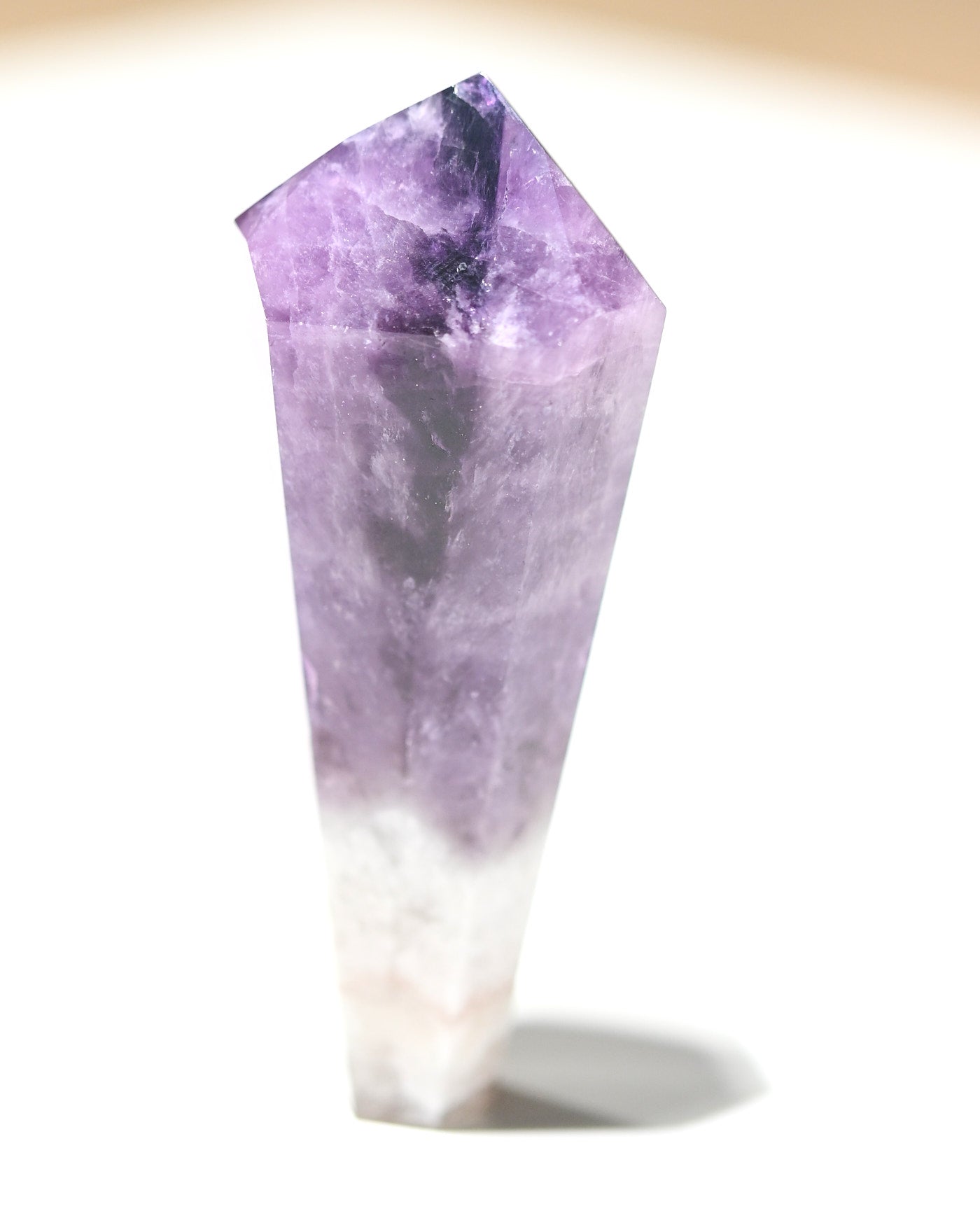 Petite trapiche amethyst point standing upright showing vivid purple coloring