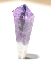 Petite trapiche amethyst point standing upright showing vivid purple coloring