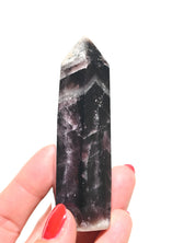 Trapiche amethyst point with intense dark purple saturation, side angle view